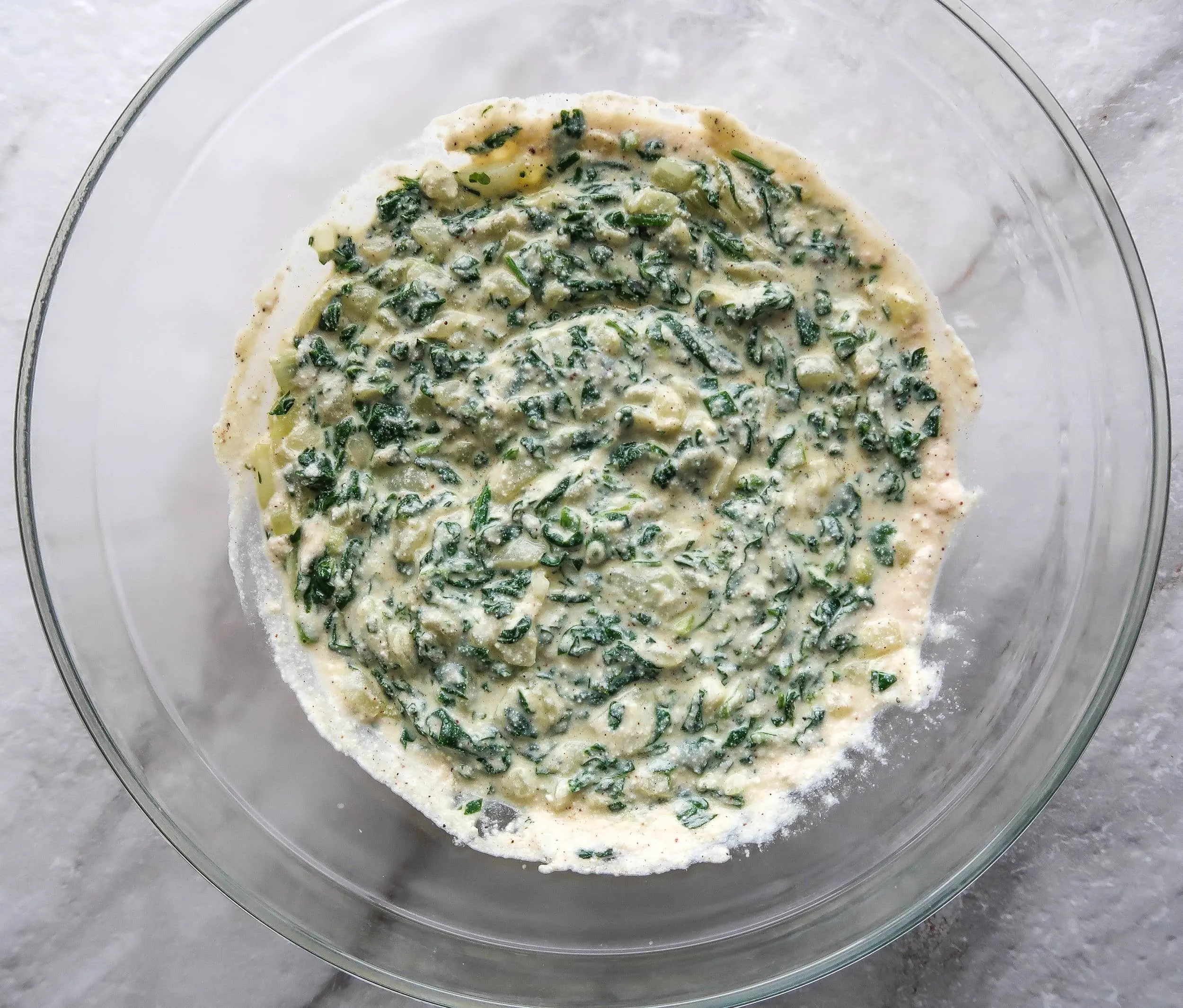 A spinach and ricotta mixture in a bowl.