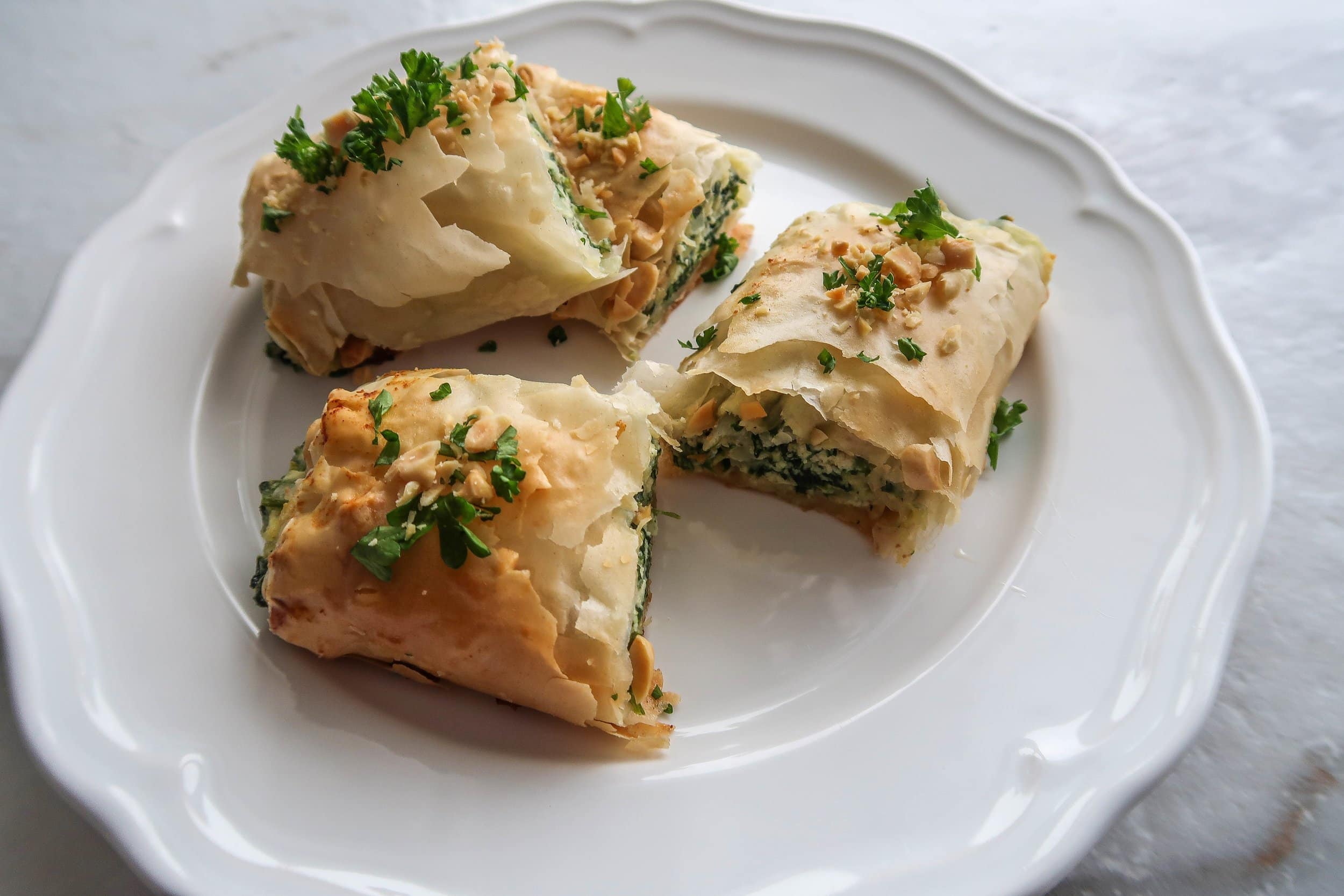 Spinach and Ricotta Spanakopita Rolls cut in half and stacked.