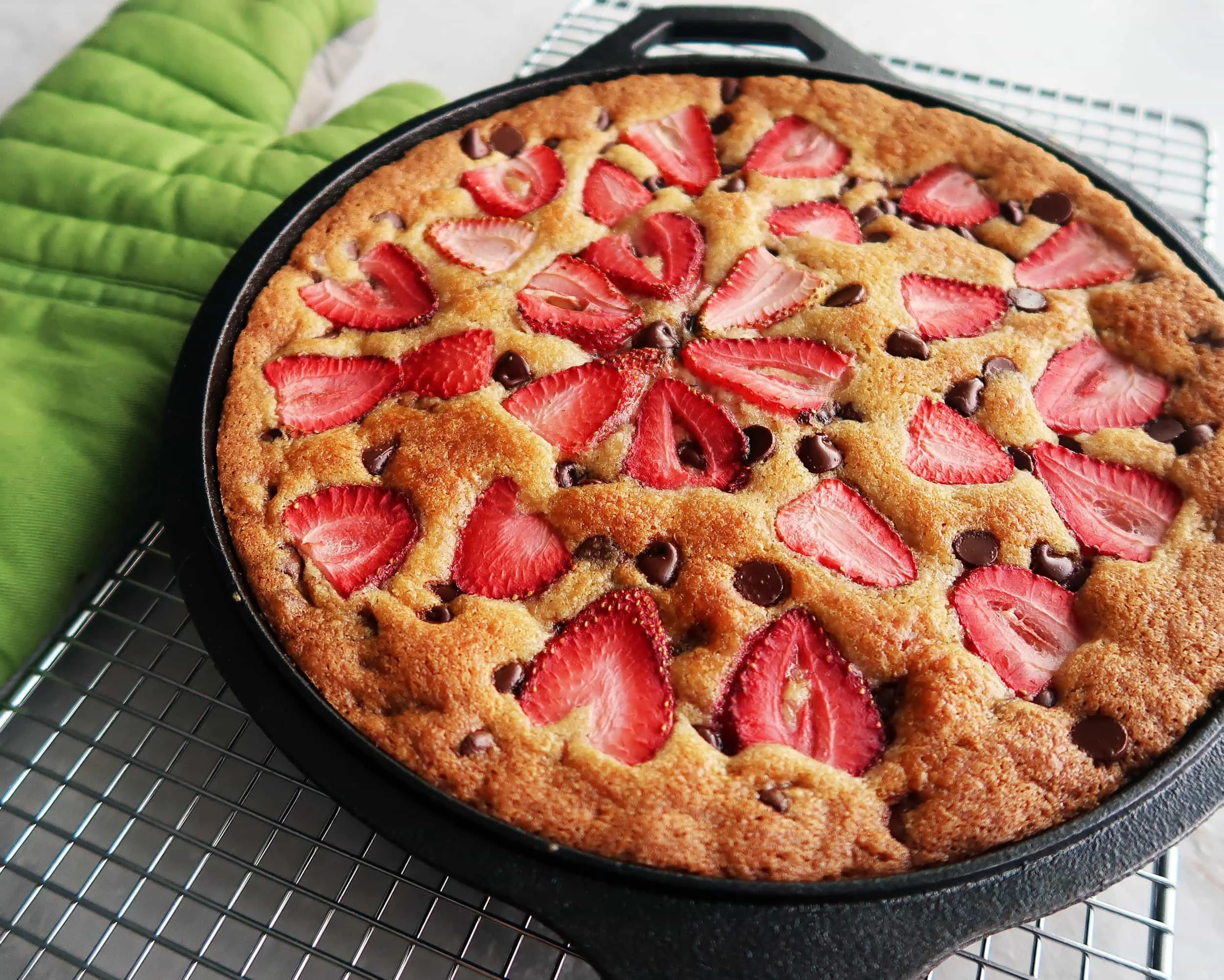 A Strawberry Chocolate Chip Skillet Cookie cooling on a rack.