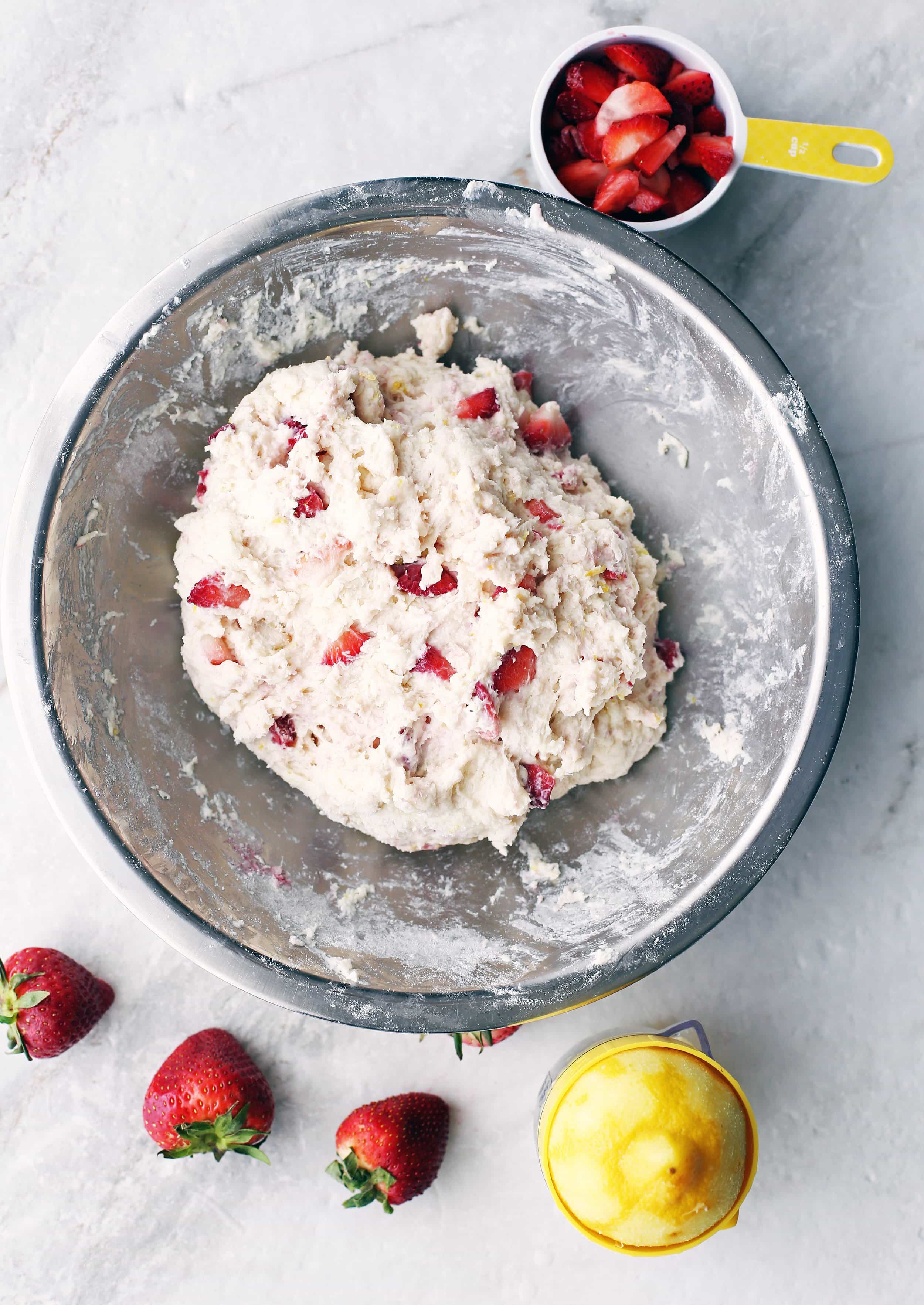 A large metal bowl containing Strawberry Lemon Yogurt Quick Bread dough.