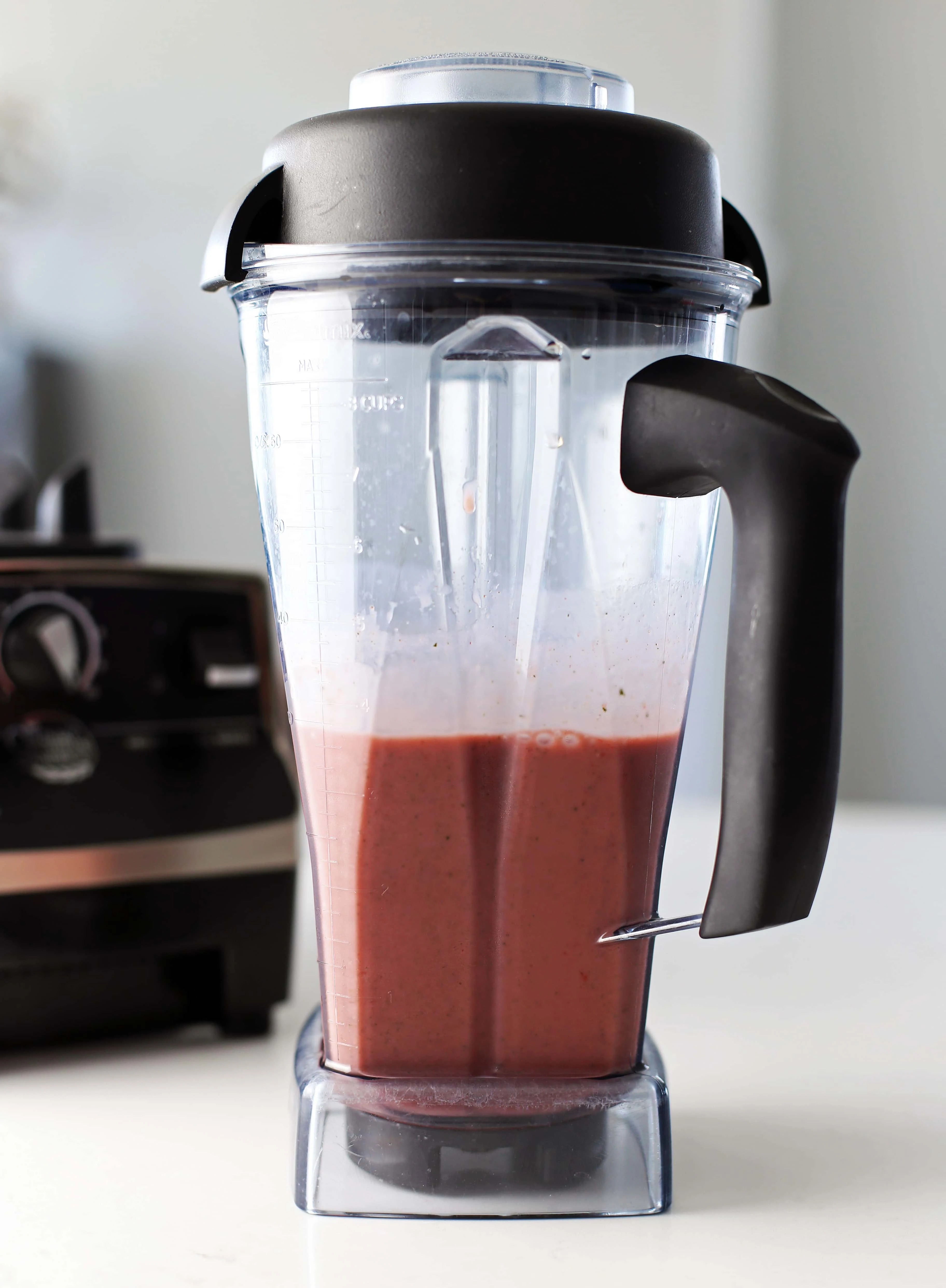 Strawberry mint smoothie in a blender container.