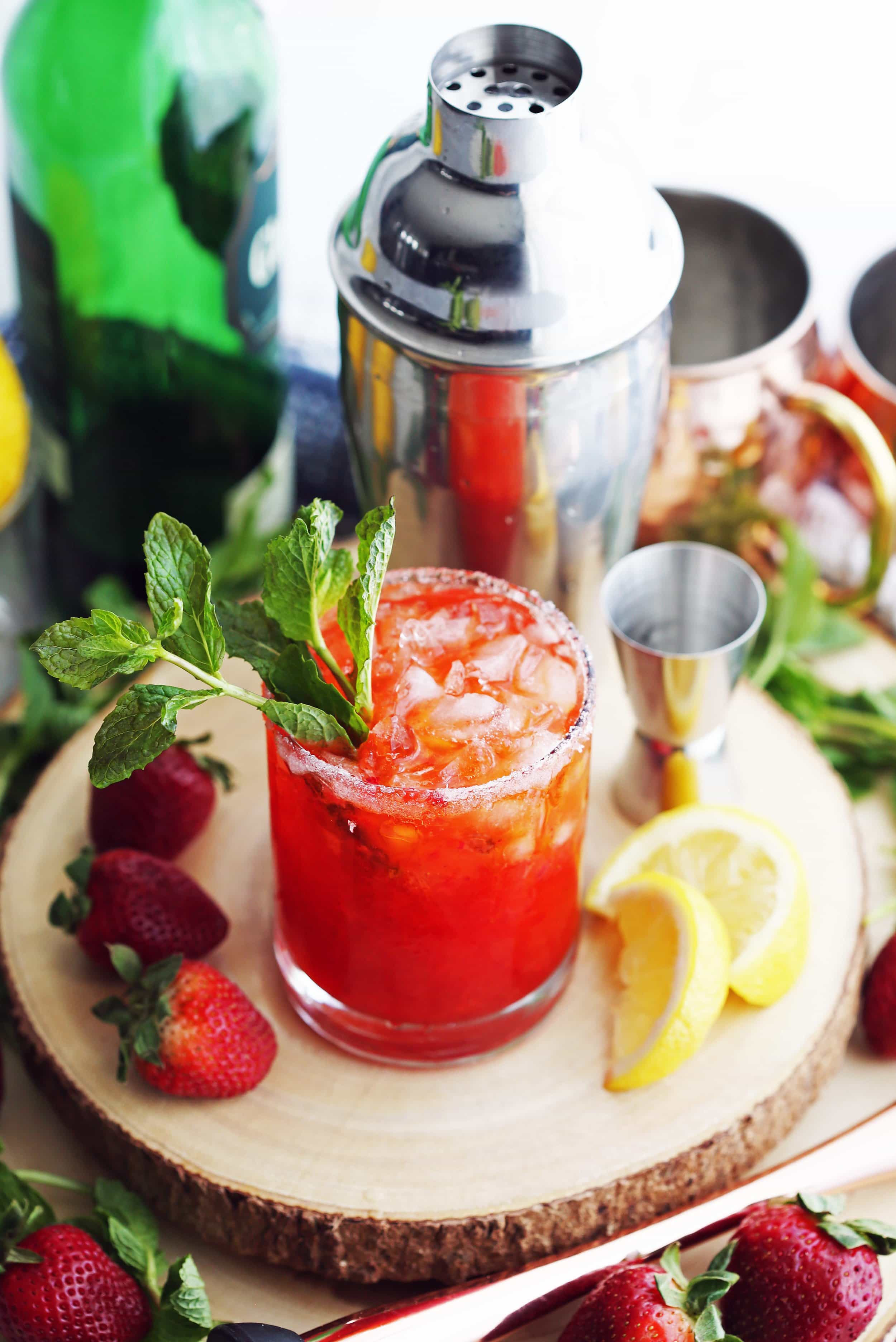 Mint Strawberry Whisky Smash Cocktail with a mint garnish in a double old fashioned glass.