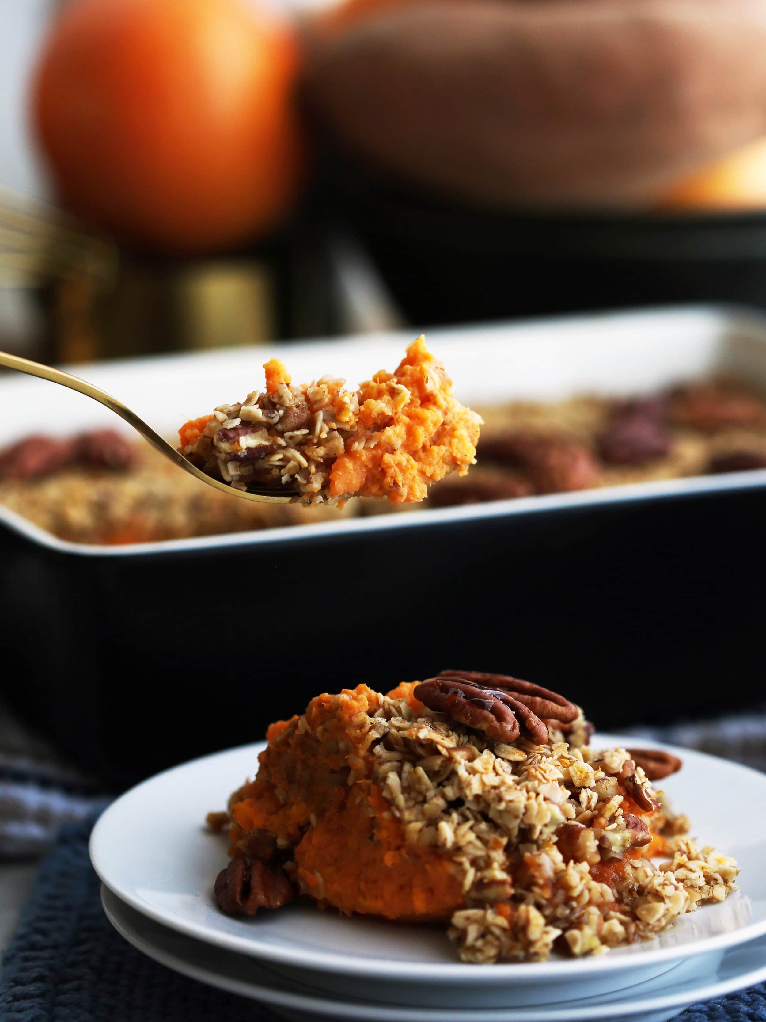 Sweet Potato Mash with Pecan Oat Topping on a fork and on a white plate.