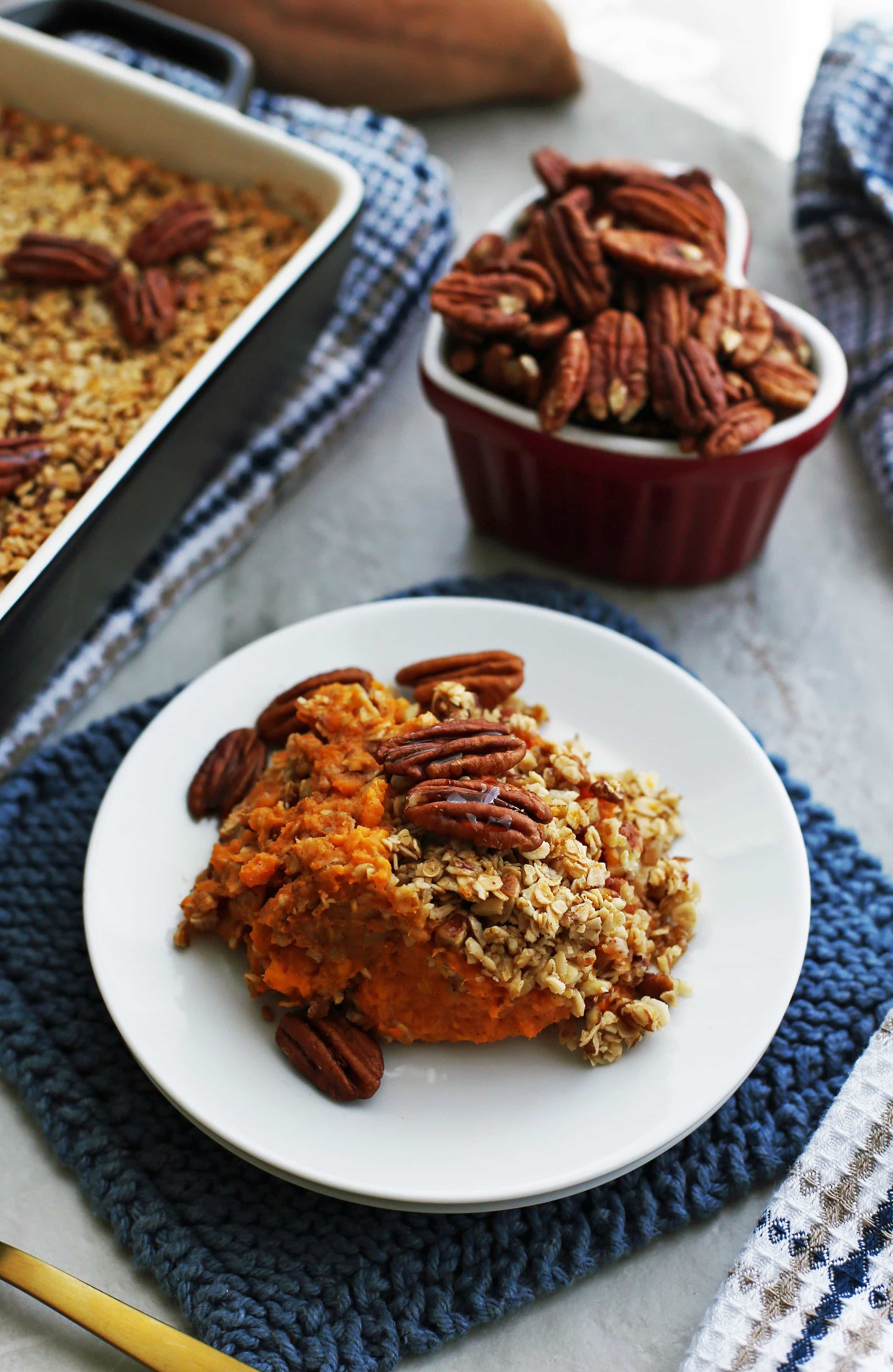 A Sweet Potato Mash with Pecan Oat Topping on a white plate.