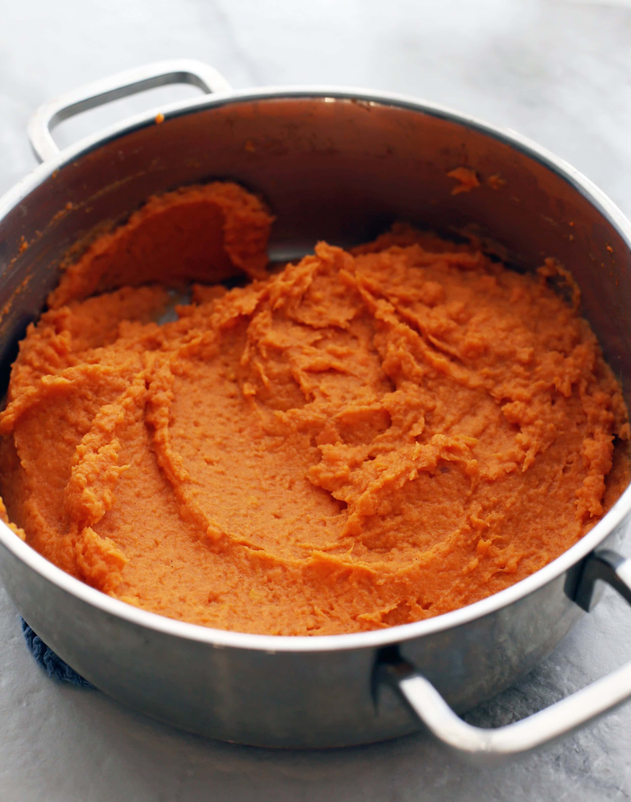 Sweet potato mash in a metal pot.