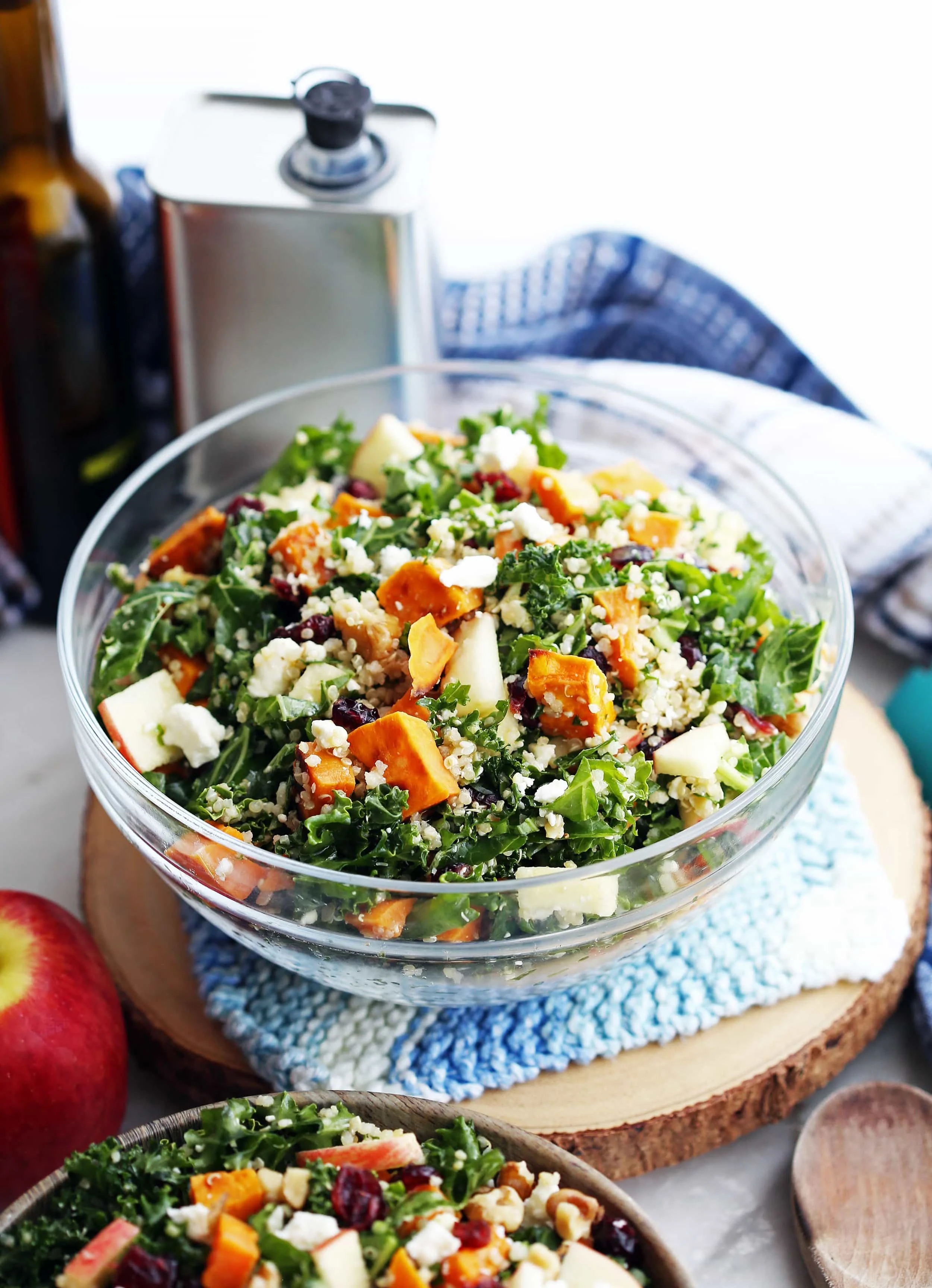Healthy roasted sweet potato quinoa kale salad in a glass bowl.