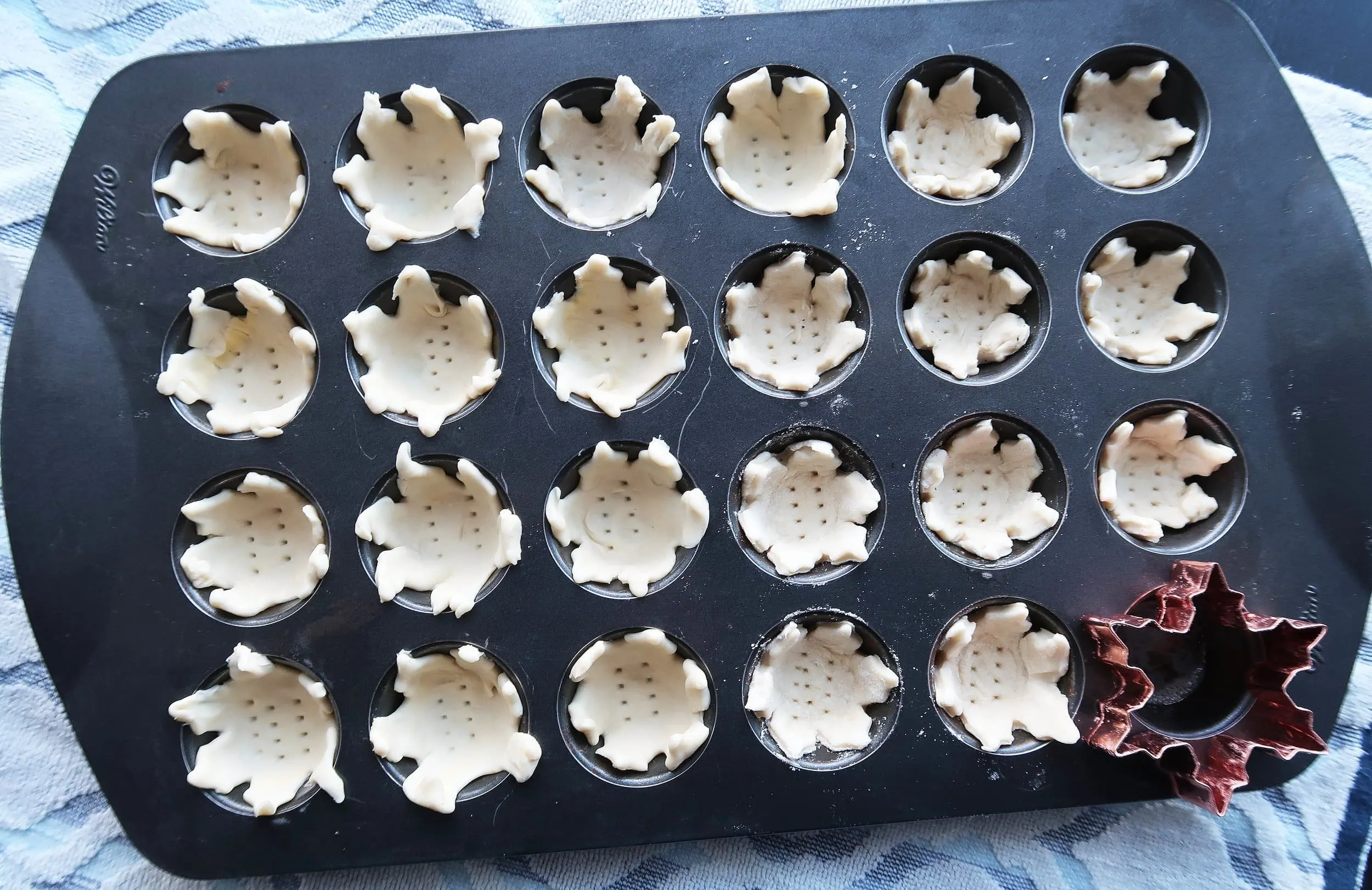 Tart dough in muffin tins.