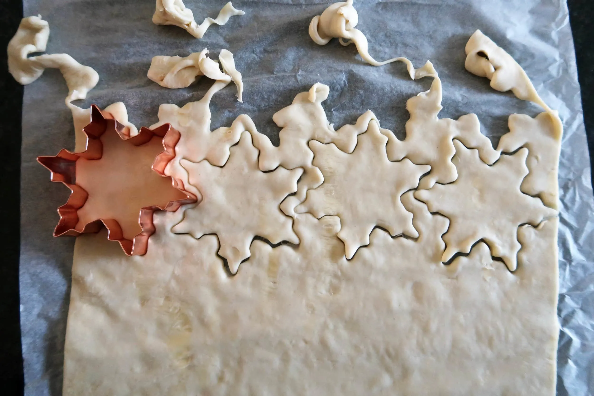 Dough pressed with a snowflake cookie cutter.