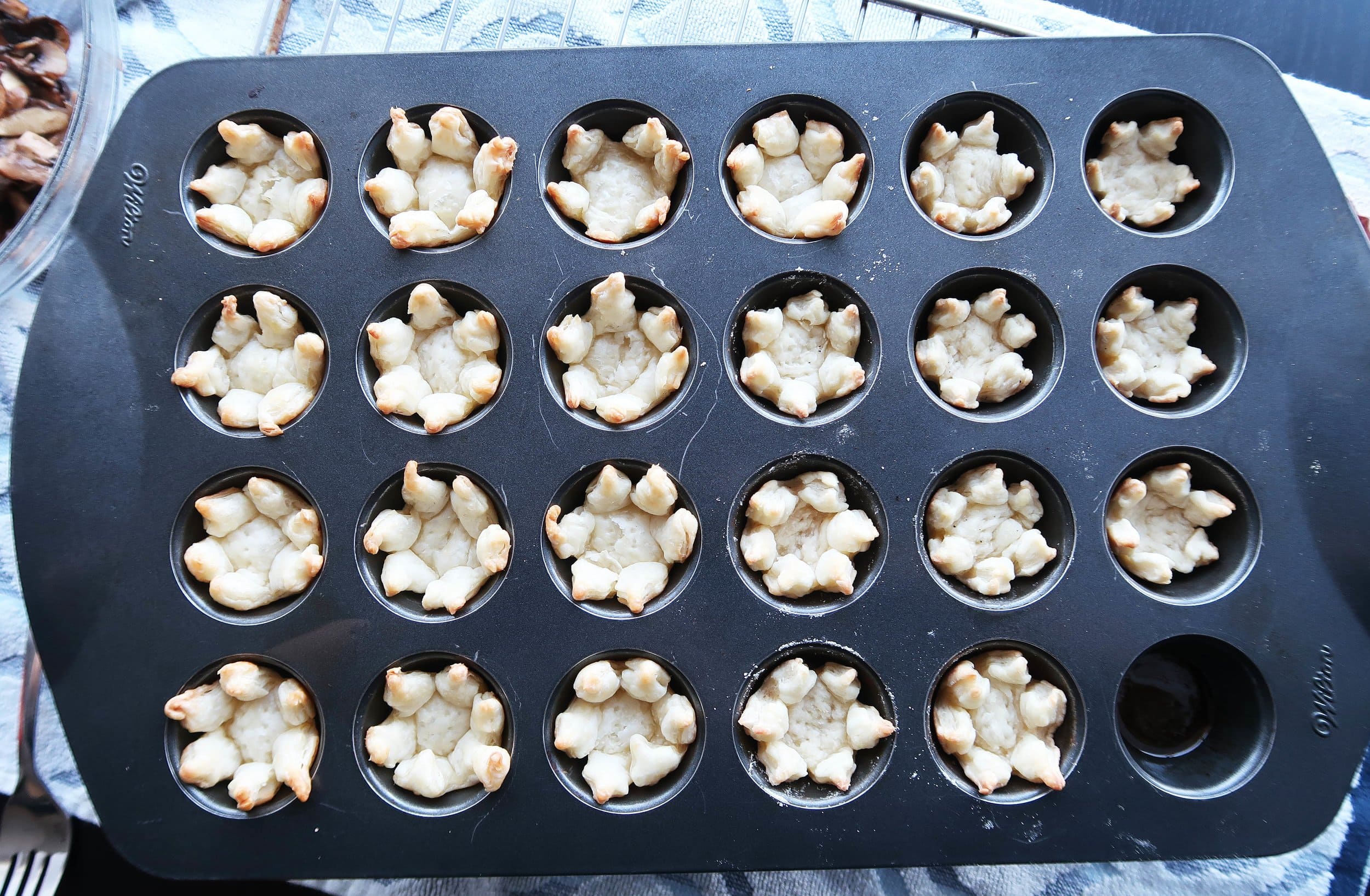 Partially baked tarts in a muffin tin.