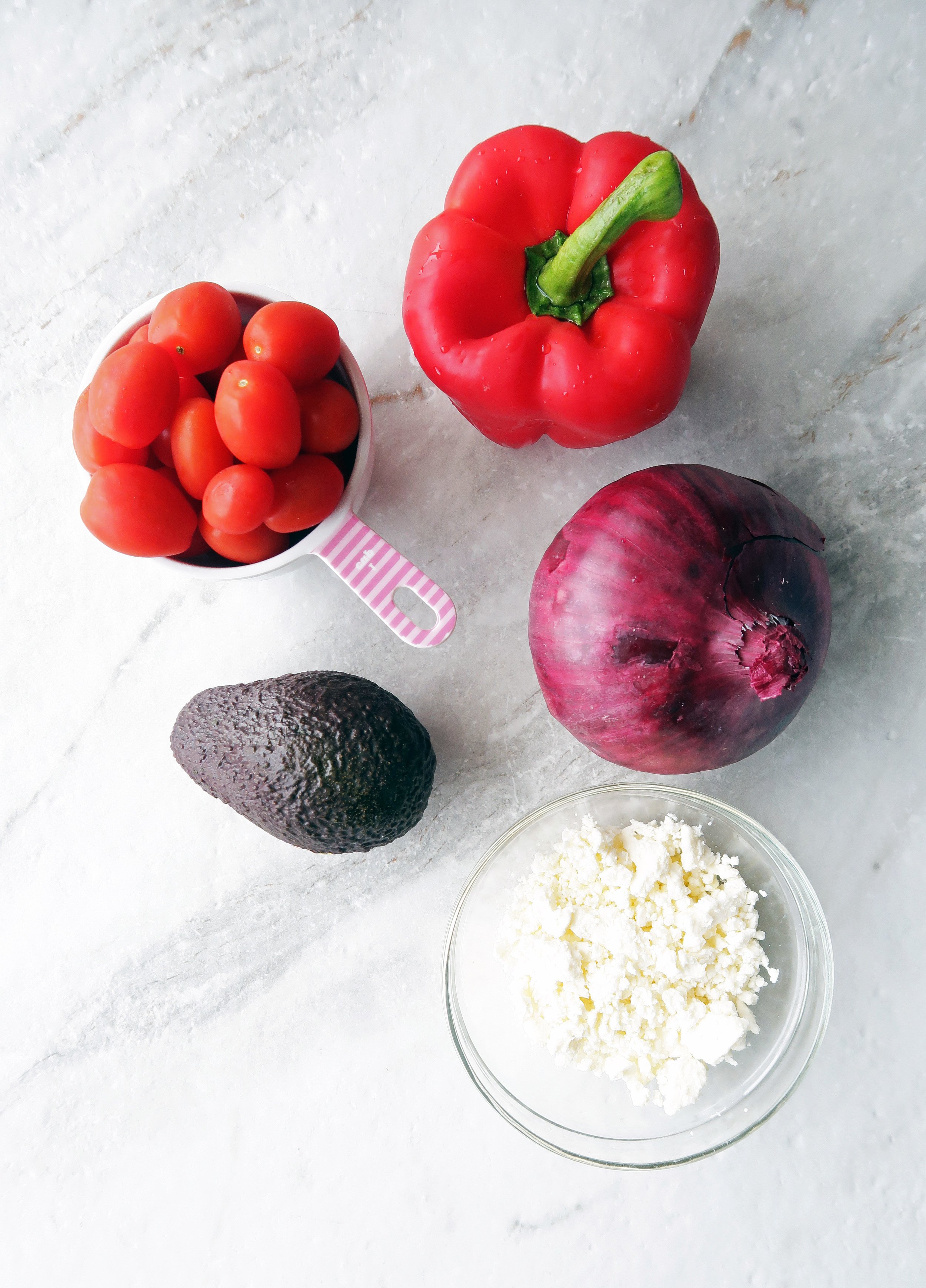 Feta cheese, red onion, avocado, red bell pepper, and grape tomatoes.