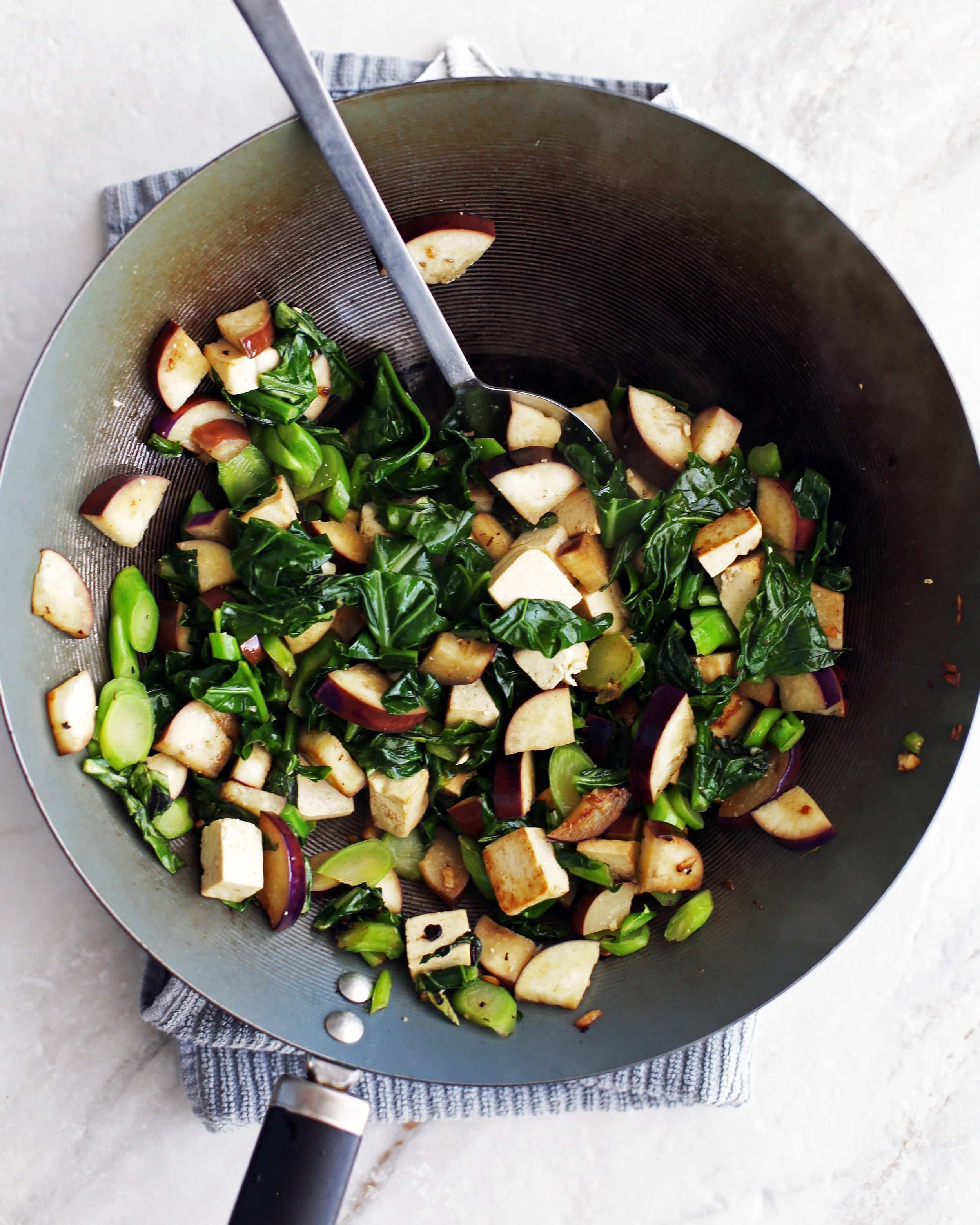 a sizzling wok full of Vegetarian Pad See Ew