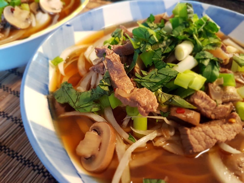 A hot bowl of Vietnamese Noodles with Beef and Mushrooms.