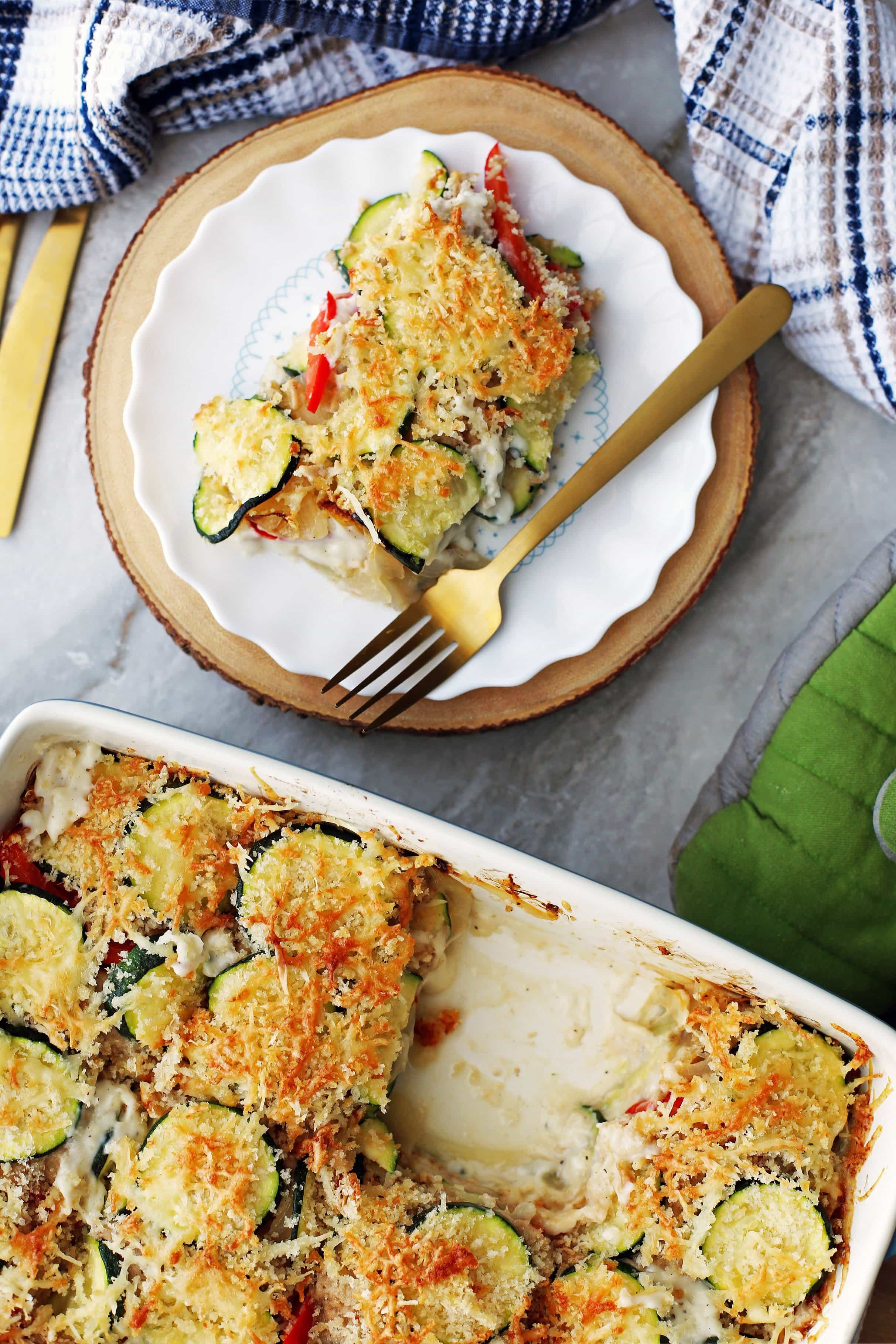 Zucchini Gratin with Gruyere and Panko Breadcrumbs in a casserole dish and on a white plate.